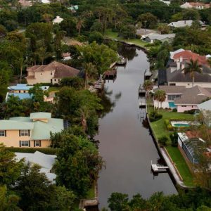 A man-made canal crowded with suburban homes